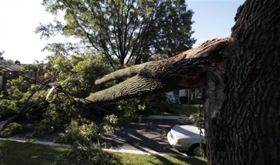 A tree fallen by Sunday's storm blocks a street in Silver Spring, Md., near Washington, on Monday.